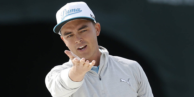 Rickie Fowler reacts after a bunker shot on the 16th hole during the first round of the Phoenix Ope...