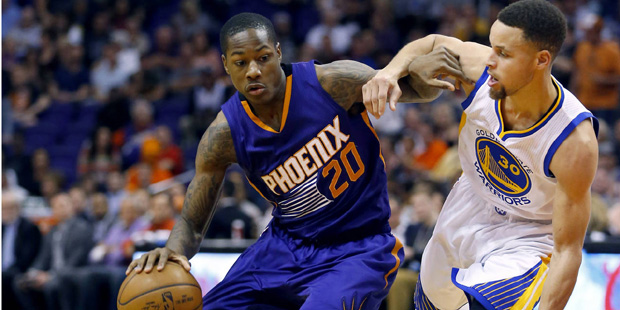 Phoenix Suns' Archie Goodwin (20) drives next to Golden State Warriors' Stephen Curry (30) during t...