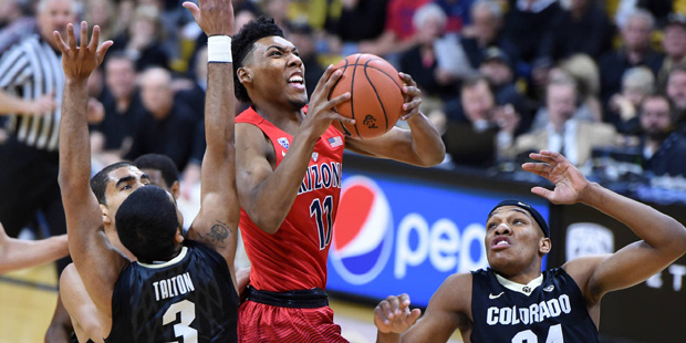 Arizona guard Allonzo Trier drives past Colorado's Xavier Talton (3) and George King during the fir...