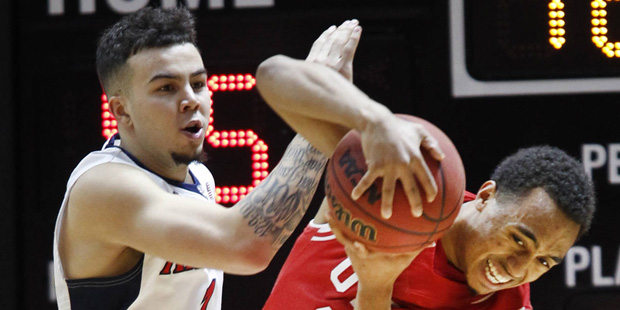 Utah guard Brandon Taylor (11) and Arizona guard Gabe York (1)fight for the ball during the second ...