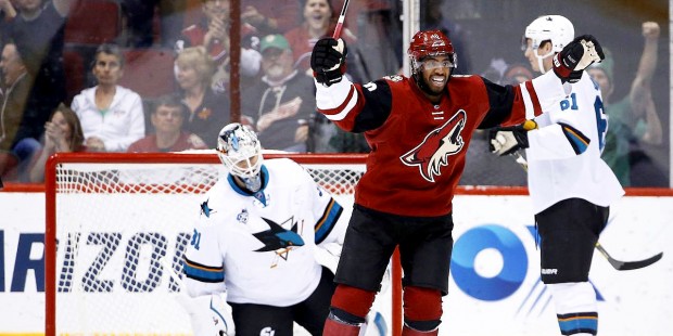 Arizona Coyotes' Anthony Duclair, front, smiles as he goes to celebrate a goal scored by Michael St...