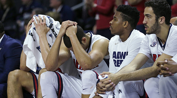 Arizona players cover their heads in the closing minute against Wichita State during the first round of the NCAA college men's basketball tournament in Providence, R.I., Thursday, March 17, 2016. Wichita State defeated Arizona 65-55. (AP Photo/Charles Krupa)