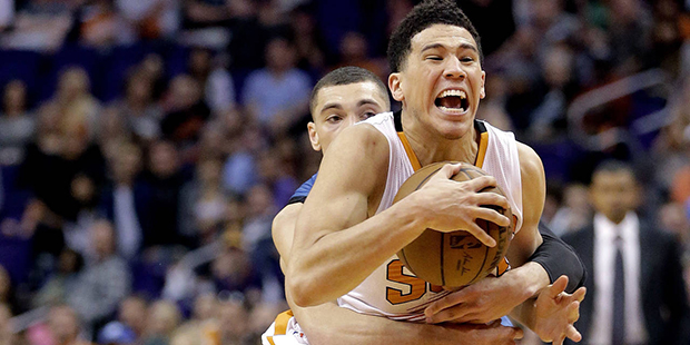Phoenix Suns' Devin Booker, front, is fouled by Minnesota Timberwolves' Zach LaVine during the seco...