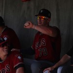 Zach Borenstein (79) tells a story to Peter O’Brien and others in the dugout.(Photo by Kylee Sam/Cronkite News)
