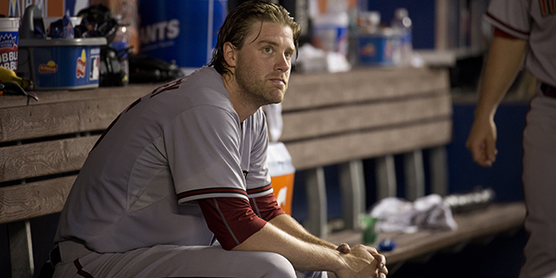 Arizona Diamondbacks starter Archie Bradley sits in the dugout during the fifth inning of a basebal...