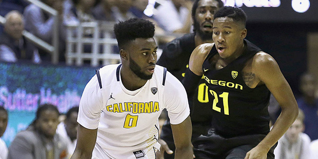 California's Jaylen Brown, left, drives the ball against Oregon's Kendall Small (21) in the second ...