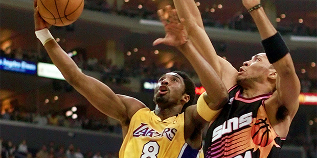 The Los Angeles Lakers' Kobe Bryant (8) drives for a basket as Shawn Marion, of the Phoenix Suns, defends during the opening quarter of game one of the Western Conference semifinals, Sunday, May 7, 2000, in Los Angeles. (AP Photo/Mark J. Terrill)