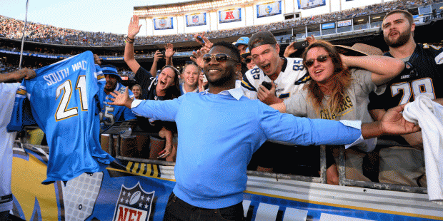 Former San Diego Chargers running back LaDainian Tomlinson poses with fans during the second half o...