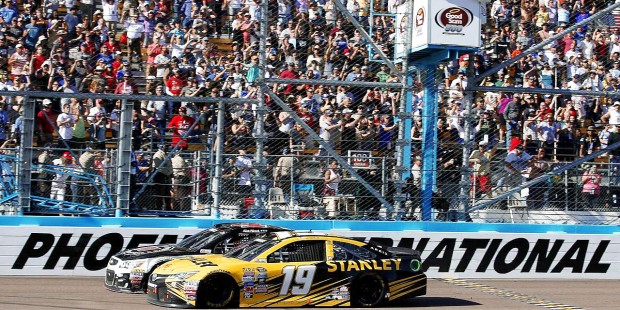 Kevin Harvick, left, beats Carl Edwards, right, at the finish line during a NASCAR Sprint Cup Serie...