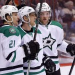 Dallas Stars' Ales Hemsky, middle, of the Czech Republic, celebrates his goal against the Arizona Coyotes with Antoine Roussel (21), of France, and Radek Faksa (12), of the Czech Republic, during the first period of an NHL hockey game, Thursday, March 24, 2016, in Glendale, Ariz. (AP Photo/Ross D. Franklin)