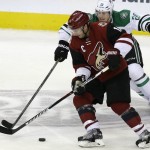 Arizona Coyotes right wing Shane Doan (19) skates with the puck against Dallas Stars center Cody Eakin (20) during the second period of an NHL hockey game Thursday, March 31, 2016, in Dallas. (AP Photo/LM Otero)