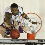 Stephen F. Austin's Thomas Walkup, bottom, drives past West Virginia's Elijah Macon, top, during the second half of a first-round men's college basketball game in the NCAA Tournament,Friday, March 18, 2016, in New York. (AP Photo/Frank Franklin II)