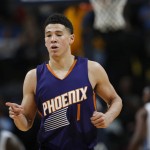 Phoenix Suns guard Devin Booker reacts after hitting a 3-point shot against the Denver Nuggets during the second half of an NBA basketball game Thursday, March 10, 2016, in Denver. The Nuggets won 116-98. (AP Photo/David Zalubowski)