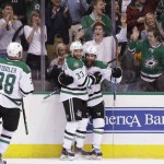 Dallas Stars right wing Patrick Eaves, right, celebrates his goal with teammates Alex Goligoski (33) and Vernon Fiddler (38) during the first period of an NHL hockey game against the Arizona Coyotes on Thursday, March 31, 2016, in Dallas. (AP Photo/LM Otero)