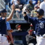 San Diego Padres' Austin Hedges, right, celebrates his two-run home run against the Arizona Diamondbacks with Adam Rosales, left, during the second inning of a spring training baseball game Tuesday, March 8, 2016, in Peoria, Ariz. (AP Photo/Ross D. Franklin)