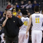 West Virginia head coach Bob Huggins, left, calls to his team during the first half of a first-round men's college basketball game against Stephen F. Austin in the NCAA Tournament,Friday, March 18, 2016, in New York. (AP Photo/Frank Franklin II)