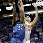 Minnesota Timberwolves' Andrew Wiggins (22) is fouled by Phoenix Suns' Alex Len during the first half of an NBA basketball game, Monday, March 14, 2016, in Phoenix. (AP Photo/Matt York)