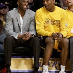 Los Angeles Lakers forwards Kobe Bryant, left, and Metta World Peace talk on the bench during the first half of the team's NBA basketball game against the Phoenix Suns in Los Angeles, Friday, March 18, 2016. (AP Photo/Chris Carlson)