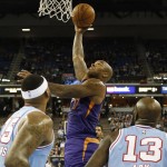 Phoenix Suns forward P.J. Tucker, center, shoots over Sacramento Kings' DeMarcus Cousins, left, and Quincy Acy during the first half of an NBA basketball game Friday, March 25, 2016, in Sacramento, Calif. (AP Photo/Rich Pedroncelli)