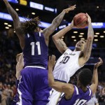 Stephen F. Austin's Clide Geffrard, Jr. (11) and Trey Pinkney (10) defend against Notre Dame's Zach Auguste (30) during the second half of a second-round men's college basketball game in the NCAA Tournament, Sunday, March 20, 2016, in New York. Notre Dame won 76-75. (AP Photo/Frank Franklin II)