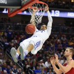 Kentucky's Jamal Murray, left, hangs from the rim after dunking over Indiana's Max Bielfeldt, right, during a second-round men's college basketball game in the NCAA Tournament in Des Moines, Iowa, Saturday, March 19, 2016. (AP Photo/Nati Harnik)