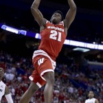 Wisconsin's Khalil Iverson (21) dunks the ball during the first half of a second-round men's college basketball game against Xavier in the NCAA Tournament, Sunday, March 20, 2016, in St. Louis. (AP Photo/Charlie Riedel)