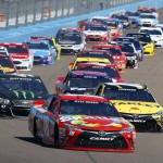 Driver Kyle Busch leads the pack into the first turn at the start of a NASCAR Sprint Cup Series auto race at Phoenix International Raceway Sunday, March 13, 2016, in Avondale, Ariz. (AP Photo/Ross D. Franklin)