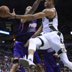 Milwaukee Bucks forward Giannis Antetokounmpo, right, passes the ball during the first half of the team's NBA basketball game against the Phoenix Suns on Wednesday, March 30, 2016, in Milwaukee. (AP Photo/Darren Hauck)