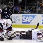 Arizona Coyotes goalie Mike Smith, right, lays down to stop a shot against the San Jose Sharks during the first period of an NHL hockey game Sunday, March 20, 2016, in San Jose, Calif. (AP Photo/Marcio Jose Sanchez)