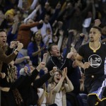 Fans celebrate a score by Golden State Warriors' Stephen Curry (30) during the second half of the team's NBA basketball game against the Phoenix Suns on Saturday, March 12, 2016, in Oakland, Calif. (AP Photo/Ben Margot)