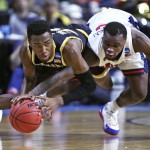 Wichita State forward Markis McDuffie, left, and Arizona guard Kadeem Allen, right, vie for a loose ball during the first half of a first-round game of the NCAA men's college basketball tournament in Providence, R.I., Thursday, March 17, 2016. (AP Photo/Charles Krupa)