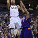 Milwaukee Bucks guard Jerryd Bayless, left, goes up for a basket against Phoenix Suns guard Brandon Knight during the first half of an NBA basketball game Wednesday, March 30, 2016, in Milwaukee. (AP Photo/Darren Hauck)