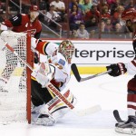 Arizona Coyotes' Anthony Duclair (10) scores a goal against Calgary Flames' Joni Ortio, middle, of Finland, as Coyotes' Martin Hanzal (11), of the Czech Republic, watches during the second period of an NHL hockey game Monday, March 28, 2016, in Glendale, Ariz. (AP Photo/Ross D. Franklin)