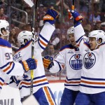 Edmonton Oilers' Jordan Eberle, second from left, celebrates his goal against the Arizona Coyotes with Connor McDavid, left, Nail Yakupov, right, of Russia, and Lauri Korpikoski, second from right, of Finland, during the first period of an NHL hockey game, Tuesday, March 22, 2016, in Glendale, Ariz. (AP Photo/Ross D. Franklin)
