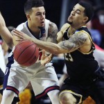 Arizona guard Gabe York, left, is pressured by Wichita State guard Fred VanVleet, right, during the first half of an NCAA college basketball game in the NCAA men's tournament in Providence, R.I., Thursday, March 17, 2016. (AP Photo/Charles Krupa)