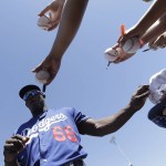 Los Angeles Dodgers right fielder Yasiel Puig (66) signs autographs for fans before a spring training baseball game between the Arizona Diamondbacks and the Dodgers in Scottsdale, Ariz., Friday, March 18, 2016. (AP Photo/Jeff Chiu)