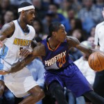 Phoenix Suns guard Archie Goodwin, right, picks up a loose ball as Denver Nuggets forward Will Barton defends during the second half of an NBA basketball game Thursday, March 10, 2016, in Denver. The Nuggets won 116-98. (AP Photo/David Zalubowski)