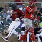 Arizona Diamondbacks' Rickie Weeks, left, scores past Los Angeles Angels catcher Carlos Perez on a double by Brandon Drury during second inning of a spring baseball game in Scottsdale, Ariz., Tuesday, March 8, 2016. (AP Photo/Chris Carlson)