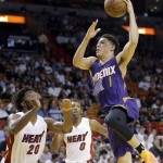 Phoenix Suns guard Devin Booker (1) prepares to shoot against Miami Heat forward Justise Winslow (20) during the first half of an NBA basketball game, Thursday, March 3, 2016, in Miami. (AP Photo/Alan Diaz)