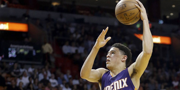 Phoenix Suns guard Devin Booker (1) prepares to shoot against Miami Heat forward Justise Winslow (2...