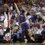 Miami Heat guard Dwyane Wade (3) shoots against Phoenix Suns guard Devin Booker (1) during the first half of an NBA basketball game, Thursday, March 3, 2016, in Miami. (AP Photo/Alan Diaz)