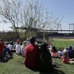 Fans watch a spring training baseball game between the Arizona Diamondbacks and the Seattle Mariners from the outfield lawn area at Salt River Fields at Talking Stick in Scottsdale, Ariz., Monday, March 14, 2016. (AP Photo/Jeff Chiu)