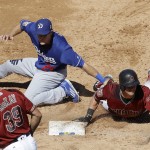 Arizona Diamondbacks' Evan Marzilli, right, slides back to first base next to Los Angeles Dodgers first baseman Chase Utley during the third inning of a spring training baseball game in Scottsdale, Ariz., Friday, March 18, 2016. (AP Photo/Jeff Chiu)