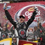 Kevin Harvick celebrates with crew members in victory lane after winning a NASCAR Sprint Cup Series auto race at Phoenix International Raceway Sunday, March 13, 2016, in Avondale, Ariz. (AP Photo/Ross D. Franklin)