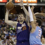 Phoenix Suns forward Mirza Teletovic, left, of Bosnia & Herzegovina, goes up for the shot against Sacramento Kings guard Marco Belinelli, of Italy during the first half of an NBA basketball game Friday, March 25, 2016, in Sacramento, Calif. (AP Photo/Rich Pedroncelli)