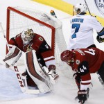 Arizona Coyotes' Mike Smith, left, makes a save on a shot by San Jose Sharks' Paul Martin (7) as Coyotes' Kevin Connauton (44) defends during the second period of an NHL hockey game Thursday, March 17, 2016, in Glendale, Ariz. (AP Photo/Ross D. Franklin)