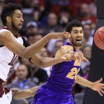 Texas A&M center Tonny Trocha-Morelos, left, and Northern Iowa guard Jeremy Morgan, right, reach for the ball in the first half of a second-round men's college basketball game in the NCAA Tournament Sunday, March 20, 2016, in Oklahoma City. (AP Photo/Alonzo Adams)