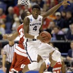 Xavier's Edmond Sumner, front, looks to the basket as Wisconsin's Vitto Brown, rear, defends during the first half in a second-round men's college basketball game in the NCAA Tournament, Sunday, March 20, 2016, in St. Louis. (AP Photo/Jeff Roberson)