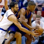 New York Knicks' Jose Calderon knocks the ball away from Phoenix Suns' Ronnie Price, right, during the first half of an NBA basketball game, Wednesday, March 9, 2016, in Phoenix. (AP Photo/Matt York)