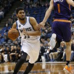 Minnesota Timberwolves center Karl-Anthony Towns (32) drives against Phoenix Suns guard Devin Booker (1) during the second half of an NBA basketball game in Minneapolis, Monday, March 28, 2016. The Timberwolves won 121-116. (AP Photo/Ann Heisenfelt)